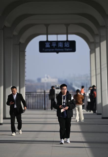 (251226) -- XI'AN, Dec. 26, 2025 (Xinhua) -- Passengers arrived are pictured at Fuping South Railway Station along the Xi'an-Yan'an high-speed railway in northwest China's Shaanxi Province, on Dec. 26, 2025. A sleek silver bullet train departed Yan'an in northwest China's Shaanxi Province on Friday, linking the sacred revolutionary heartland to the country's rapidly expanding high-speed rail network.
   The newly opened 299-km line connects Yan'an with Xi'an, the provincial capital and home to the famed Terracotta Warriors, slashing travel time between the two cities from about 2.5 hours to roughly one hour.
   Designed for operations of up to 350 km per hour, the line marked the fastest train running on the Loess Plateau. (Xinhua/Li Yibo)