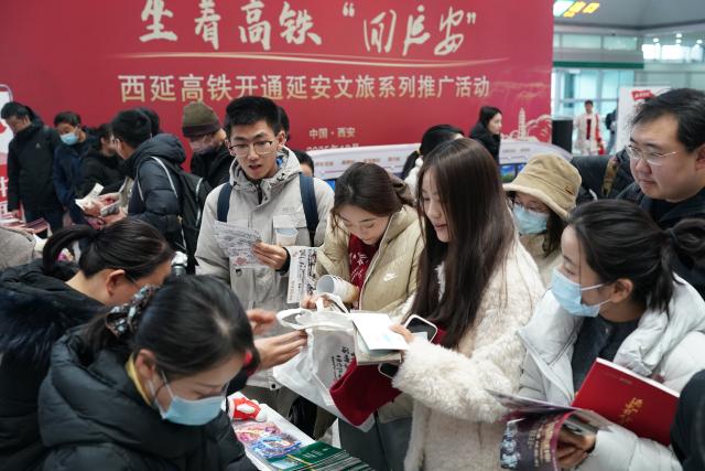 (251226) -- XI'AN, Dec. 26, 2025 (Xinhua) -- Passengers attend a promotional event marking the operation of Xi'an-Yan'an high-speed railway at Xi'an North Railway Station in Xi'an, northwest China's Shaanxi Province, Dec. 26, 2025. A sleek silver bullet train departed Yan'an in northwest China's Shaanxi Province on Friday, linking the sacred revolutionary heartland to the country's rapidly expanding high-speed rail network.
   The newly opened 299-km line connects Yan'an with Xi'an, the provincial capital and home to the famed Terracotta Warriors, slashing travel time between the two cities from about 2.5 hours to roughly one hour.
   Designed for operations of up to 350 km per hour, the line marked the fastest train running on the Loess Plateau. (Xinhua/Shao Rui)