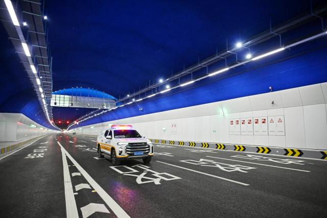 (251226) -- QINGDAO, Dec. 26, 2025 (Xinhua) -- A highway patrol vehicle passes through the Laohu Mountain Tunnel in Qingdao, east China's Shandong Province, Dec. 26, 2025. The Laohu Mountain Tunnel is an integral part of the Tangshan Road interchange and connection line project along the Qingdao-Yinchuan Expressway, which was opened to traffic on Friday. 
   The tunnel spans a total length of 1,551 meters and features eight lanes in a bidirectional double-tunnel configuration. Its maximum excavation span is 31.8 meters, with a maximum excavation cross-section of 447.62 square meters. (Xinhua/Li Ziheng)