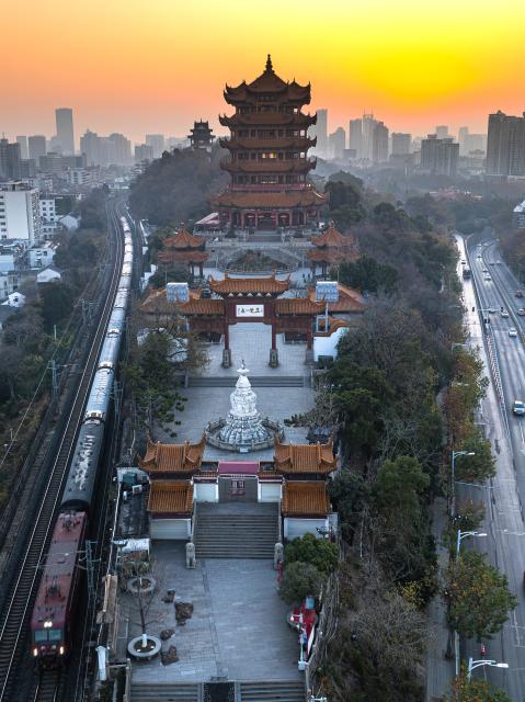 (251226) -- WUHAN, Dec. 26, 2025 (Xinhua) -- An aerial drone photo taken on Dec. 26, 2025 shows the Yellow Crane Tower at sunrise in Wuhan, central China's Hubei Province. (Xinhua/Xiao Yijiu)