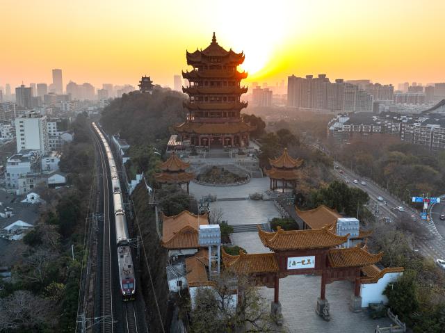 (251226) -- WUHAN, Dec. 26, 2025 (Xinhua) -- An aerial drone photo taken on Dec. 26, 2025 shows the Yellow Crane Tower at sunrise in Wuhan, central China's Hubei Province. (Xinhua/Xiao Yijiu)