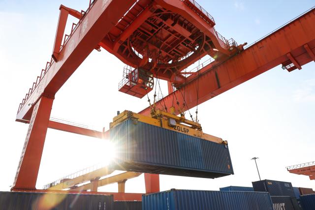 (251226) -- SUIFENHE, Dec. 26, 2025 (Xinhua) -- Transshipment operations are conducted for the China-Europe freight trains at a container transshipment yard of Suifenhe Railway Station in Suifenhe, northeast China's Heilongjiang Province, on Dec. 25, 2025. As a vital part of the eastern corridor of the China-Europe freight train network, the Suifenhe Railway Port has handled more than 4,000 China-Europe freight train trips since its launch in 2018, carrying over 390,000 TEUs of cargo, according to data from China Railway Harbin Group Co., Ltd. (Photo by Qu Yiwei/Xinhua)