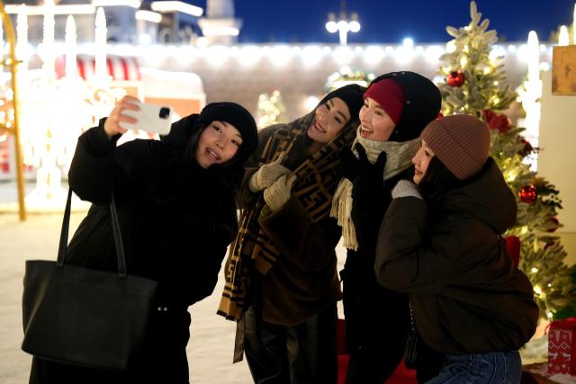 (251226) -- ASTANA, Dec. 26, 2025 (Xinhua) -- Local residents take selfies at a New Year-themed park at Independence Square in Astana, Kazakhstan, Dec. 26, 2025. Astana has been adorned in festive decorations recently as the New Year approaches. (Photo by Kalizhan Ospanov/Xinhua)