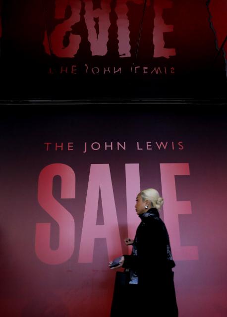 (251226) -- LONDON, Dec. 26, 2025 (Xinhua) -- A woman walks past a sale sign on Oxford Street during Boxing Day sales in London, Britain, on Dec. 26, 2025. (Xinhua/Li Ying)
