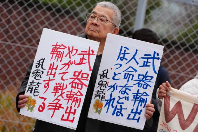 (251227) -- BEIJING, Dec. 27, 2025 (Xinhua) -- A protester attends a rally against the ruling coalition's plan to ease arms export in front of the headquarters of the Liberal Democratic Party (LDP) in Tokyo, Japan, on Dec. 25, 2025. Japanese protesters held a rally on Thursday afternoon in front of the headquarters of the LDP in Tokyo, voicing strong opposition to a plan by the ruling coalition to relax restrictions on exports of weapons significantly. (Xinhua/Jia Haocheng)