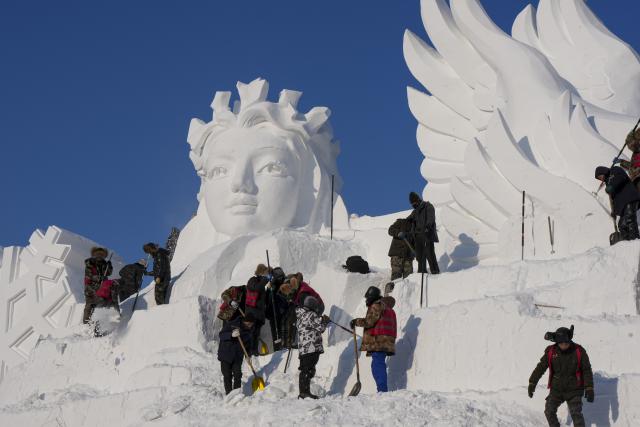 (251227) -- HARBIN, Dec. 27, 2025 (Xinhua) -- Artisans work on a snow sculpture at the venue of the 38th Sun Island International Snow Sculpture Art Expo in Harbin, northeast China's Heilongjiang Province, Dec. 26, 2025. The 38th Sun Island International Snow Sculpture Art Expo opened here for trial on Saturday, with an exhibition area of 1.5 million square meters and a snow-using volume of 120,000 cubic meters. (Xinhua/Wang Song)