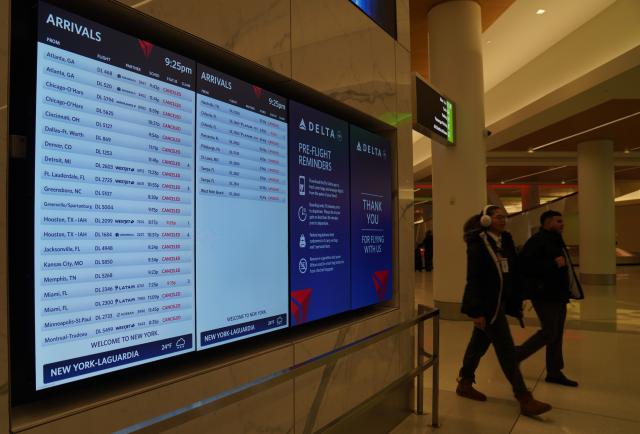 (251227) -- NEW YORK, Dec. 27, 2025 (Xinhua) -- A screen shows many flights cancelled due to a snowstorm at LaGuardia Airport in New York, the United States, on Dec. 26, 2025. A snowstorm hitting New York on Friday, which has caused flight delays and cancellations. (Xinhua/Zhang Fengguo)