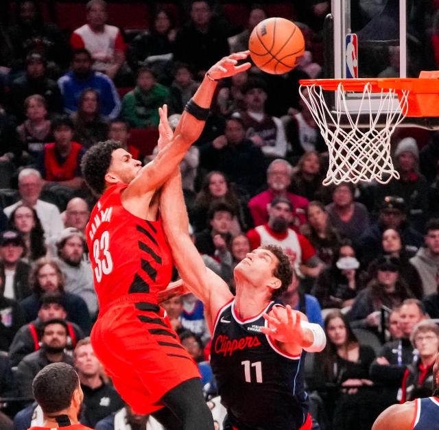 (251227) -- PORTLAND, Dec. 27, 2025 (Xinhua) -- Toumani Camara (L) of Portland Trail Blazers shoots past Brook Lopez of Los Angeles Clippers during the 2025-2026 NBA regular season match between Portland Trail Blazers and Los Angeles Clippers in Portland, the United States, Dec. 26, 2025. (Photo by Sun Yuxuan/Xinhua)