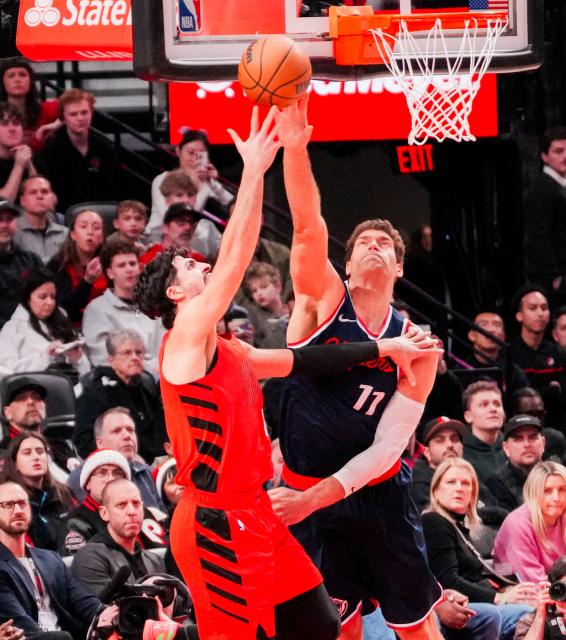 (251227) -- PORTLAND, Dec. 27, 2025 (Xinhua) -- Brook Lopez (R) of Los Angeles Clippers blocks Deni Avdija of Portland Trail Blazers during the 2025-2026 NBA regular season match between Portland Trail Blazers and Los Angeles Clippers in Portland, the United States, Dec. 26, 2025. (Photo by Sun Yuxuan/Xinhua)