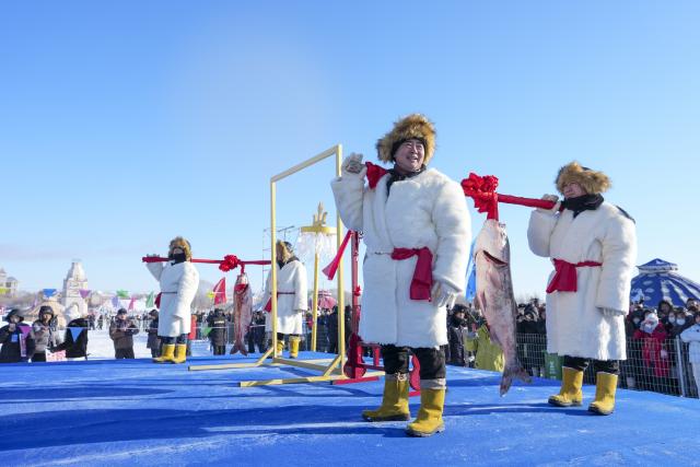 (251227) -- DAQING, Dec. 27, 2025 (Xinhua) -- People perform during a winter fishing event of a Nadam fair in Mongolian Autonomous County of Dorbod, Daqing City, northeast China's Heilongjiang Province, Dec. 27, 2025. An ice and snow Nadam fair featuring winter fishing kicked off here on Saturday. The integrated development fishery, and cultural and tourism industry in Dorbod has not only boosted tourism market, but also increased the income of local fishermen. (Xinhua/Wang Song)