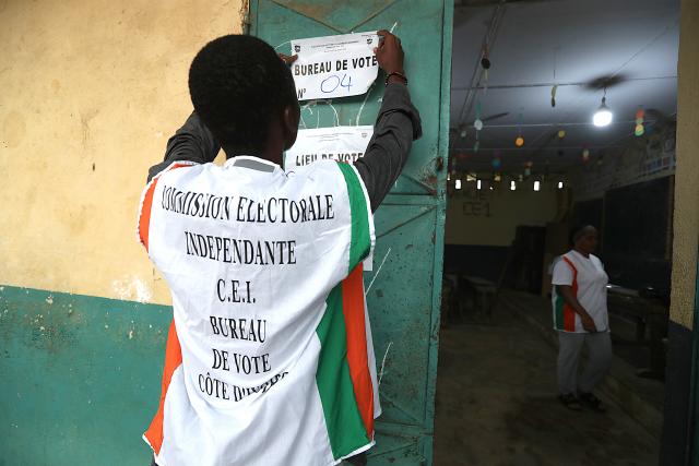 (251227) -- ABIDJAN, Dec. 27, 2025 (Xinhua) -- A staff member posts polling station information at the entrance of a polling station in Abidjan, Cote d'Ivoire, Dec. 27, 2025. Polling stations opened on Saturday morning across Cote d'Ivoire for legislative elections to renew the 255 seats of the National Assembly, Xinhua reporters observed on site in Abidjan, the country's economic capital.
TO GO WITH "Polling opens for legislative elections in Cote d'Ivoire " (Photo by Yvan Sonh/Xinhua)