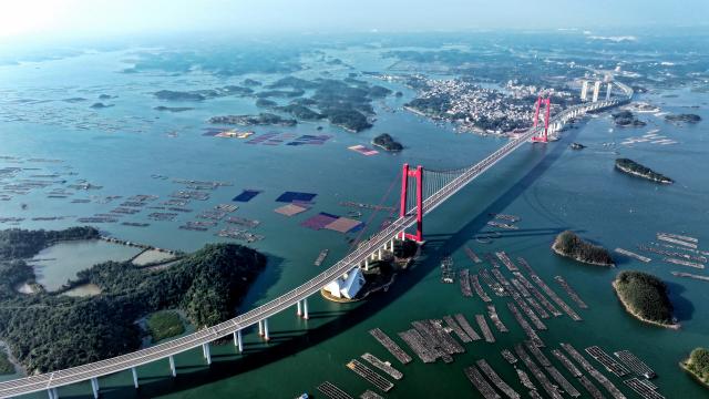 (251227) -- QINZHOU, Dec. 27, 2025 (Xinhua) -- An aerial drone photo taken on Dec. 27, 2025 shows the Longmen Bridge in Qinzhou, south China's Guangxi Zhuang Autonomous Region. In winter, the Maowei Sea in Guangxi presents picturesque scenery. In recent years, Guangxi has implemented high-standard ecological protection of the marine environment in the Beibu Gulf, transforming the Maowei Sea into a new cultural and tourism landmark. (Xinhua/Zhang Ailin)