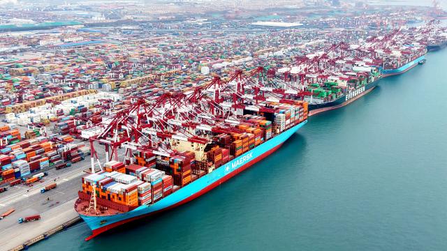 (251227) -- JINAN, Dec. 27, 2025 (Xinhua) -- This aerial drone photo taken on Dec. 27, 2025 shows cargo ships loading and unloading containers at Qingdao Port in east China's Shandong Province. Shandong's port cargo throughput this year exceeded 1.9 billion tonnes on Saturday, with container volume surpassing 47 million TEUs. (Photo by Yu Fangping/Xinhua)