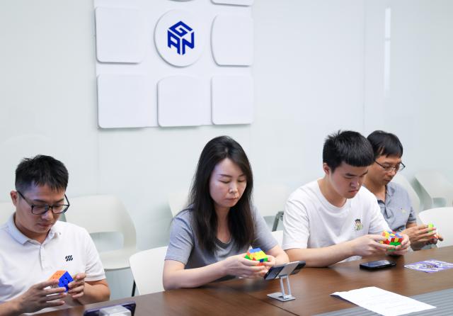 (251227) -- FOSHAN, Dec. 27, 2025 (Xinhua) -- Employees of the technology company GANCUBE participate in a Rubik's Cube competition held within the company in Shunde, Foshan City, south China's Guangdong Province, Oct. 29, 2025. As traditional toys are stuck in price and homogenization competition, a batch of smart educational toys is quietly opening up new markets at home and abroad.
   In this emerging market segment, Giiker from Shunde of Foshan City, stands out. Founded in 2018, Giiker started with a Rubik's Cube product and has reached an annual gross merchandise volume of over 500 million yuan (about 71.36 million U.S. dollars) in just six years.
   Founder Su Ziming said that unlike the traditional toy industry's strategy of pursuing rapid launch and extensive distribution of new products, Giiker prefers to spend one to two years refining a product, emphasizing a long-term life cycle and high quality.
   Another outstanding company in this market segment is GANCUBE, a technology company also based in south China's Guangdong Province. It entered the market in 2014,  and has now developed into a smart competitive platform covering smart hardware, AI algorithms, and IoT ecosystem.  In the global smart competitive toy segment, GANCUBE holds approximately 20 percent of the market share. 
   Behind the rapid development lies its continuous R&D and manufacturing investment. GANCUBE has multiple production bases, including a digital factory of over 15,000 square meters. The team has a high proportion of R&D personnel, and it has even independently developed an automated cube production line that is rare in the industry. Its products are sold through platforms like Amazon and Tmall to over 100 countries and regions.
   The rise of smart educational toys reflects not only the upgrade of China's toy industry but also the evolution of educational concepts and consumption trends. As "learning through play" becomes a consensus, this market segment is attracting more and more innovators. (Xinhua/Huo Siying)