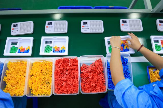 (251227) -- FOSHAN, Dec. 27, 2025 (Xinhua) -- A worker works on the production line of Giiker in Shunde, Foshan City, south China's Guangdong Province, Oct. 29, 2025. As traditional toys are stuck in price and homogenization competition, a batch of smart educational toys is quietly opening up new markets at home and abroad.
   In this emerging market segment, Giiker from Shunde of Foshan City, stands out. Founded in 2018, Giiker started with a Rubik's Cube product and has reached an annual gross merchandise volume of over 500 million yuan (about 71.36 million U.S. dollars) in just six years.
   Founder Su Ziming said that unlike the traditional toy industry's strategy of pursuing rapid launch and extensive distribution of new products, Giiker prefers to spend one to two years refining a product, emphasizing a long-term life cycle and high quality.
   Another outstanding company in this market segment is GANCUBE, a technology company also based in south China's Guangdong Province. It entered the market in 2014,  and has now developed into a smart competitive platform covering smart hardware, AI algorithms, and IoT ecosystem.  In the global smart competitive toy segment, GANCUBE holds approximately 20 percent of the market share. 
   Behind the rapid development lies its continuous R&D and manufacturing investment. GANCUBE has multiple production bases, including a digital factory of over 15,000 square meters. The team has a high proportion of R&D personnel, and it has even independently developed an automated cube production line that is rare in the industry. Its products are sold through platforms like Amazon and Tmall to over 100 countries and regions.
   The rise of smart educational toys reflects not only the upgrade of China's toy industry but also the evolution of educational concepts and consumption trends. As "learning through play" becomes a consensus, this market segment is attracting more and more innovators. (Xinhua/Mao Siqian)