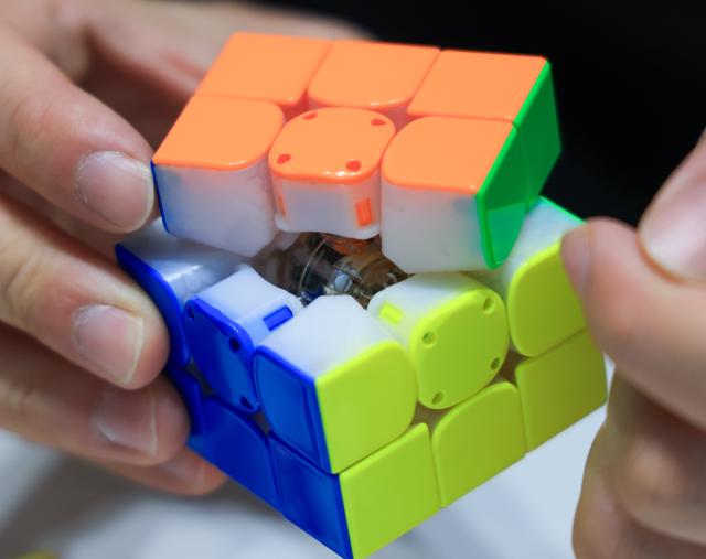 (251227) -- FOSHAN, Dec. 27, 2025 (Xinhua) -- Jiang Ganyuan, founder of the technology company GANCUBE, shows the built-in sensor and bluetooth chip inside a smart Rubik's Cube in Shunde, Foshan City, south China's Guangdong Province, Oct. 29, 2025. As traditional toys are stuck in price and homogenization competition, a batch of smart educational toys is quietly opening up new markets at home and abroad.
   In this emerging market segment, Giiker from Shunde of Foshan City, stands out. Founded in 2018, Giiker started with a Rubik's Cube product and has reached an annual gross merchandise volume of over 500 million yuan (about 71.36 million U.S. dollars) in just six years.
   Founder Su Ziming said that unlike the traditional toy industry's strategy of pursuing rapid launch and extensive distribution of new products, Giiker prefers to spend one to two years refining a product, emphasizing a long-term life cycle and high quality.
   Another outstanding company in this market segment is GANCUBE, a technology company also based in south China's Guangdong Province. It entered the market in 2014,  and has now developed into a smart competitive platform covering smart hardware, AI algorithms, and IoT ecosystem.  In the global smart competitive toy segment, GANCUBE holds approximately 20 percent of the market share. 
   Behind the rapid development lies its continuous R&D and manufacturing investment. GANCUBE has multiple production bases, including a digital factory of over 15,000 square meters. The team has a high proportion of R&D personnel, and it has even independently developed an automated cube production line that is rare in the industry. Its products are sold through platforms like Amazon and Tmall to over 100 countries and regions.
   The rise of smart educational toys reflects not only the upgrade of China's toy industry but also the evolution of educational concepts and consumption trends. As "learning through play" becomes a consensus, this market segment is attracting more and more innovators. (Xinhua/Huo Siying)