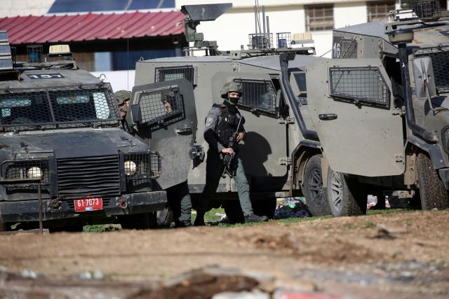 (251228) -- QABATIYA, Dec. 28, 2025 (Xinhua) -- Israeli military vehicles and soldiers are pictured during a military operation in the town of Qabatiya, south of Jenin in the West Bank on Dec. 27, 2025.
  In the northern West Bank, Israeli troops maintained a tight siege on the town of Qabatiya for a second day. Qabatiya's Mayor Ahmed Zakarneh said Israeli forces have closed entrances, imposed a curfew, damaged infrastructure and raided homes. (Photo by Nidal Eshtayeh/Xinhua)