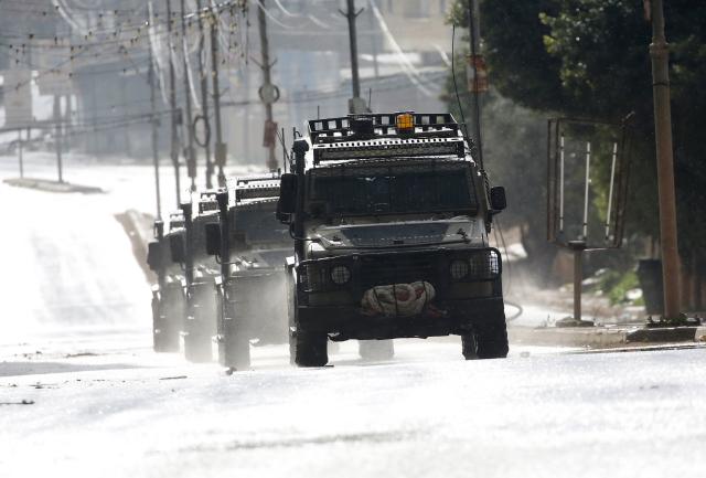 (251228) -- QABATIYA, Dec. 28, 2025 (Xinhua) -- Israeli military vehicles are pictured during a military operation in the town of Qabatiya, south of Jenin in the West Bank on Dec. 27, 2025.
  In the northern West Bank, Israeli troops maintained a tight siege on the town of Qabatiya for a second day. Qabatiya's Mayor Ahmed Zakarneh said Israeli forces have closed entrances, imposed a curfew, damaged infrastructure and raided homes. (Photo by Nidal Eshtayeh/Xinhua)
