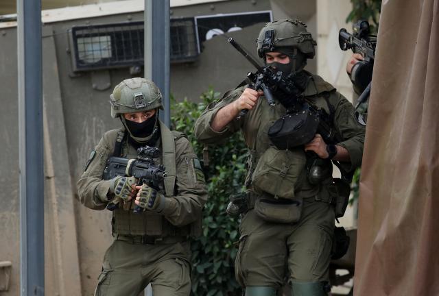 (251228) -- QABATIYA, Dec. 28, 2025 (Xinhua) -- Israeli soldiers are pictured during a military operation on a street in the town of Qabatiya, south of Jenin in the West Bank on Dec. 27, 2025.
  In the northern West Bank, Israeli troops maintained a tight siege on the town of Qabatiya for a second day. Qabatiya's Mayor Ahmed Zakarneh said Israeli forces have closed entrances, imposed a curfew, damaged infrastructure and raided homes. (Photo by Nidal Eshtayeh/Xinhua)
