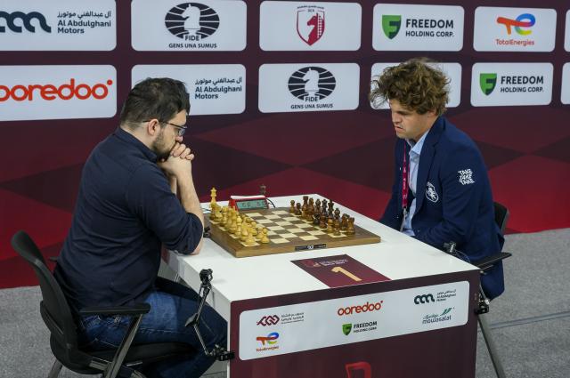 (251228) -- DOHA, Dec. 28, 2025 (Xinhua) -- Magnus Carlsen (R) of Norway competes during the Rapid Open sixth round against Maxime Vachier-Lagrave of India at the FIDE World Rapid & Blitz Championships 2025 in Doha, Qatar, on Dec. 27, 2025. (Photo by Nikku/Xinhua)