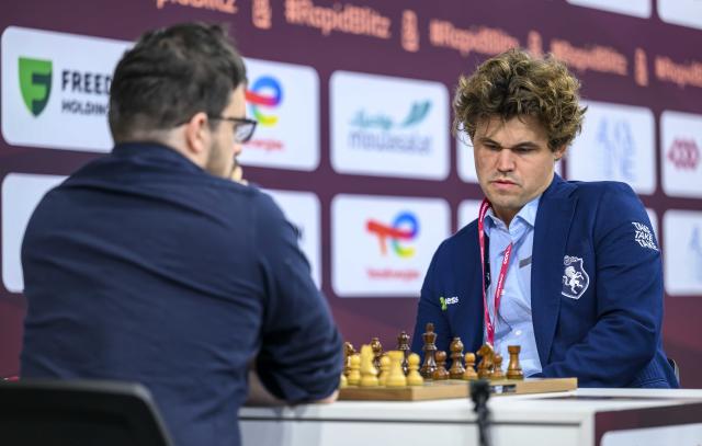 (251228) -- DOHA, Dec. 28, 2025 (Xinhua) -- Magnus Carlsen (R) of Norway competes during the Rapid Open sixth round against Maxime Vachier-Lagrave of India at the FIDE World Rapid & Blitz Championships 2025 in Doha, Qatar, on Dec. 27, 2025. (Photo by Nikku/Xinhua)