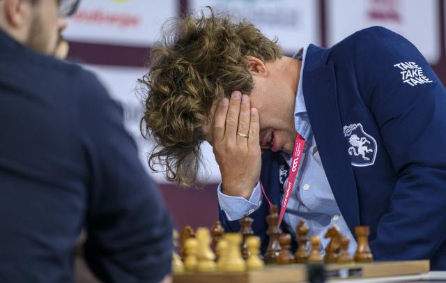 (251228) -- DOHA, Dec. 28, 2025 (Xinhua) -- Magnus Carlsen of Norway reacts during the Rapid Open sixth round against Maxime Vachier-Lagrave of India at the FIDE World Rapid & Blitz Championships 2025 in Doha, Qatar, on Dec. 27, 2025. (Photo by Nikku/Xinhua)