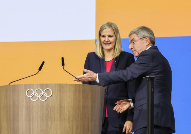 (251228) -- BEIJING, Dec. 28, 2025 (Xinhua) -- Here is Xinhua News Agency's selection of the 10 most significant pieces of international sports news in 2025: On March 20, Zimbabwe's former Olympic swimming champion Kirsty Coventry was elected the International Olympic Committee (IOC) president during the 144th IOC Session in Greece, becoming the organization's first female president and the first from outside Europe and North America.
After taking office in June, Coventry initiated a "Pause and Reflect" process and set up four working groups focusing on areas including the Youth Olympic Games and the Olympic program.
This file photo taken on March 20, 2025 shows Thomas Bach (R) inviting Kirsty Coventry to deliver a speech after she being elected as the 10th president of the International Olympic Committee (IOC) during the 144th IOC session in Costa Navarino, Greece. (Xinhua/Cao Can)