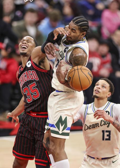 (251228) -- CHICAGO, Dec. 28, 2025 (Xinhua) -- Kevin Porter Jr. (C) of Milwaukee Bucks and Isaac Okoro (L) of Milwaukee Bucks battle for a rebound during NBA regular season basketball game between Milwaukee Bucks and Chicago Bulls at United Center in Chicago, the United States, on Dec. 27, 2025. (Photo by Joel Lerner/Xinhua)