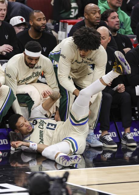(251228) -- CHICAGO, Dec. 28, 2025 (Xinhua) -- Ryan Rollins (bottom) of Milwaukee Bucks tumbles into the bench area during NBA regular season basketball game between Milwaukee Bucks and Chicago Bulls at United Center in Chicago, the United States, on Dec. 27, 2025. (Photo by Joel Lerner/Xinhua)