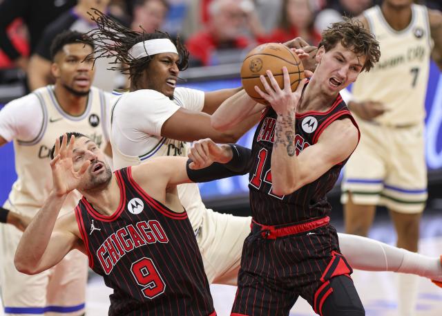 (251228) -- CHICAGO, Dec. 28, 2025 (Xinhua) -- Matas Buzelis (1st R) of Chicago Bulls grabs a rebound during NBA regular season basketball game between Milwaukee Bucks and Chicago Bulls at United Center in Chicago, the United States, on Dec. 27, 2025. (Photo by Joel Lerner/Xinhua)
