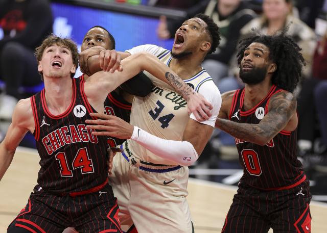(251228) -- CHICAGO, Dec. 28, 2025 (Xinhua) -- Matas Buzelis (1st L) and Coby White (1st R) of Chicago Bulls battle for position with Giannis Antetokounmpo (2nd R) of Milwaukee Bucks during NBA regular season basketball game between Milwaukee Bucks and Chicago Bulls at United Center in Chicago, the United States, on Dec. 27, 2025. (Photo by Joel Lerner/Xinhua)