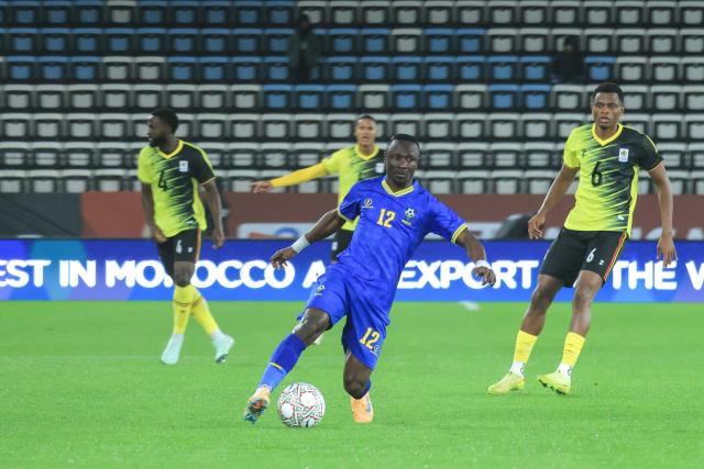 (251228) -- MOROCCO, Dec. 28, 2025 (Xinhua) -- Saimon Msuva (front) of Tanzania controls the ball during the group C match between Tanzania and Uganda at the Africa Cup of Nations 2025 in Rabat, Morocco, Dec. 27, 2025. (Photo by Hajarah Nalwadda/Xinhua)
