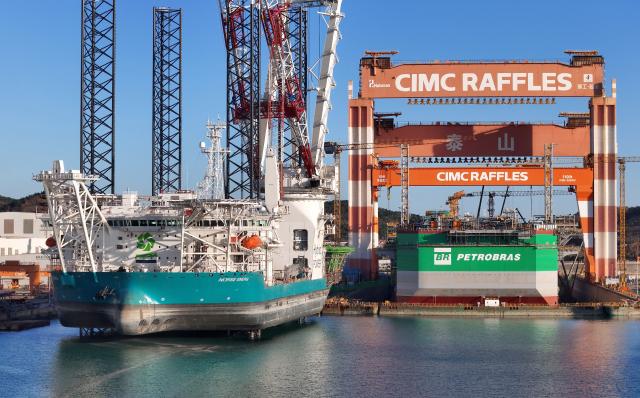 (251228) -- JINAN, Dec. 28, 2025 (Xinhua) -- An aerial drone photo taken on Dec. 24, 2025 shows the marine engineering equipment conducting building work at the construction base of CIMC Raffles in Yantai, east China's Shandong Province. In recent years, Shandong has been committed to building a high-end industrial cluster integrating shipbuilding and marine engineering equipment in Shandong Peninsula, embarking on a high-quality development path driven by the marine economy. (Photo by Tang Ke/Xinhua)