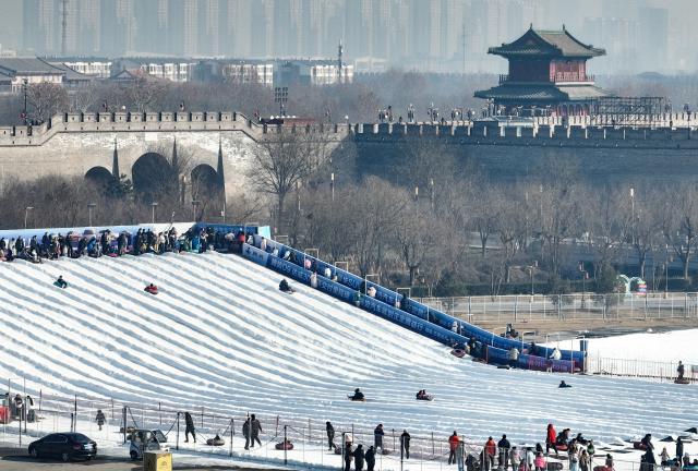 (251228) -- BEIJING, Dec. 28, 2025 (Xinhua) -- This aerial drone photo taken on Dec. 28, 2025 shows people playing in an ice-and-snow theme park in Zhengding County of north China's Hebei Province. (Photo by Zhang Xiaofeng/Xinhua)