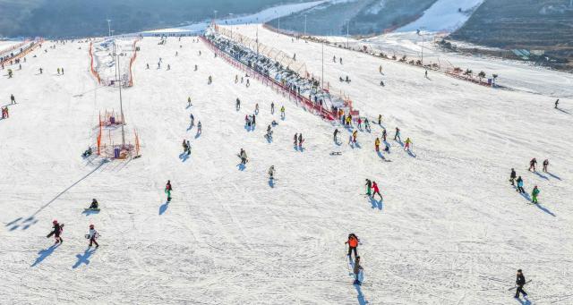 (251228) -- BEIJING, Dec. 28, 2025 (Xinhua) -- This aerial drone photo taken on Dec. 28, 2025 shows people skiing at a ski resort in Yutian County of north China's Hebei Province. (Photo by Liu Mancang/Xinhua)