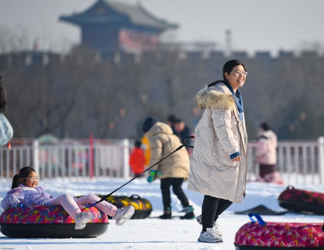 (251228) -- BEIJING, Dec. 28, 2025 (Xinhua) -- People play in an ice-and-snow theme park in Zhengding County of north China's Hebei Province, Dec. 28, 2025. (Photo by Zhang Xiaofeng/Xinhua)