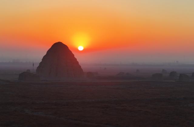 (251228) -- YINCHUAN, Dec. 28, 2025 (Xinhua) -- A drone photo taken on Dec. 28, 2025 shows a Xixia imperial tomb at sunrise in Yinchuan, northwest China's Ningxia Hui Autonomous Region. China's Xixia Imperial Tombs were officially added to the UNESCO World Heritage List on July 11, 2025 during the 47th session of the World Heritage Committee held in Paris, France. (Photo by Yuan Hongyan/Xinhua)