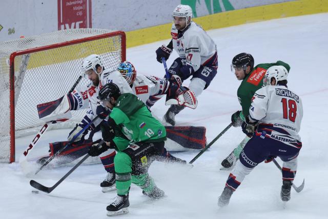 (251229) -- LJUBLJANA, Dec. 29, 2025 (Xinhua) -- Alex Petan (2nd L) of Olimpija Ljubljana vies with Martin Stajnoch (1st L) of Hydro Fehervar AV 19 during the 2025/26 Win2day Ice Hockey League match between Olimpija LJubljana and Hydro Fehervar AV 19 in Ljubljana, Slovenia, Dec. 28, 2025. (Photo by Zeljko Stevanic/Xinhua)