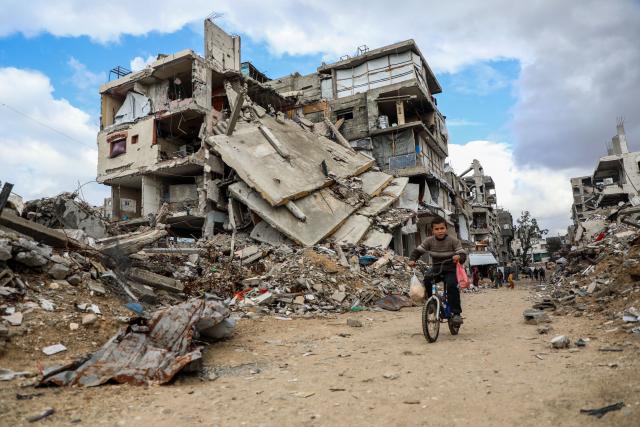 (251229) -- GAZA, Dec. 29, 2025 (Xinhua) -- A displaced Palestinian boy rides a bicycle at the Jabalia refugee camp in the northern Gaza Strip, on Dec. 28, 2025. A child and a woman were killed in a severe storm affecting the Gaza Strip, the region's Civil Defense announced Sunday. (Photo by Rizek Abdeljawad/Xinhua)
