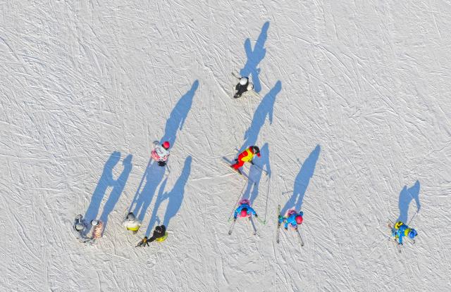 (251229) -- BEIJING, Dec. 29, 2025 (Xinhua) -- This aerial drone photo taken on Dec. 28, 2025 shows people skiing at a ski resort in Yutian County of north China's Hebei Province. (Photo by Liu Mancang/Xinhua)