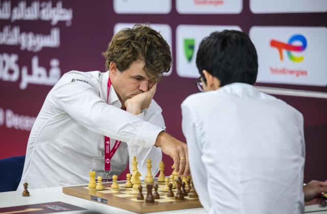 (251229) -- DOHA, Dec. 29, 2025 (Xinhua) -- Magnus Carlsen (L) of Norway competes during the Rapid Open final round against Anish Giri of the Netherlands at the FIDE World Rapid & Blitz Championships 2025 in Doha, Qatar, Dec. 28, 2025. (Photo by Nikku/Xinhua)