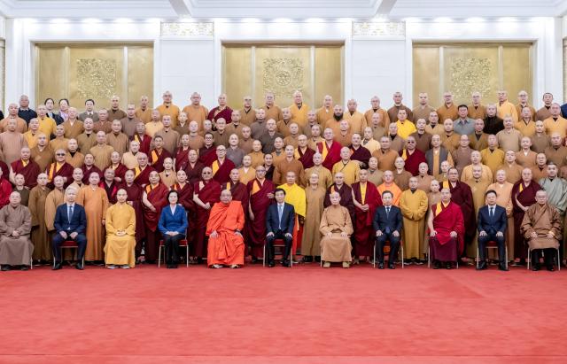 (251229) -- BEIJING, Dec. 29, 2025 (Xinhua) -- Wang Huning, a member of the Standing Committee of the Political Bureau of the Communist Party of China (CPC) Central Committee and chairman of the Chinese People's Political Consultative Conference (CPPCC) National Committee, poses for a group photo with delegates attending a national congress of the Buddhist Association of China in Beijing, capital of China. The 11th national congress of the Buddhist Association of China was held from Sunday to Monday in Beijing. (Xinhua/Zhai Jianlan)