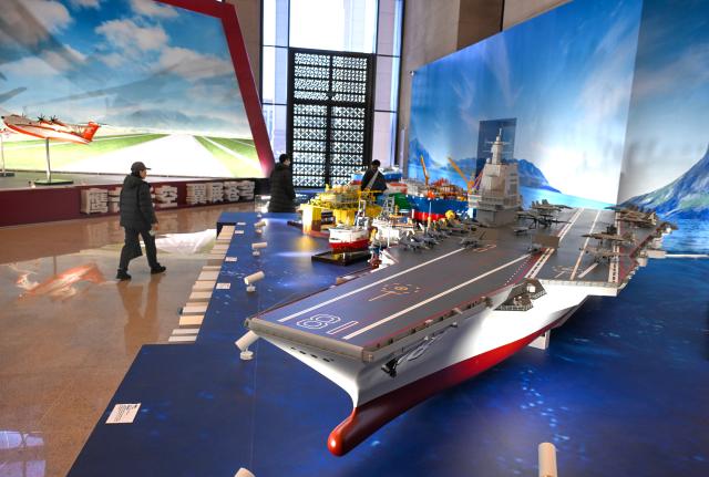 (251229) -- BEIJING, Dec. 29, 2025 (Xinhua) -- This photo taken on Dec. 29, 2025 shows the model of China's aircraft carrier Fujian at the exhibition "Forging the Path to National Strength: China's Manufacturing Achievements under the 14th Five-Year Plan" at the National Museum of China in Beijing, capital of China. With more than 300 pieces (sets) exhibits, the exhibition kicked off here on Monday, showcasing China's manufacturing achievements under the 14th Five-Year Plan. (Xinhua/Jin Liangkuai)