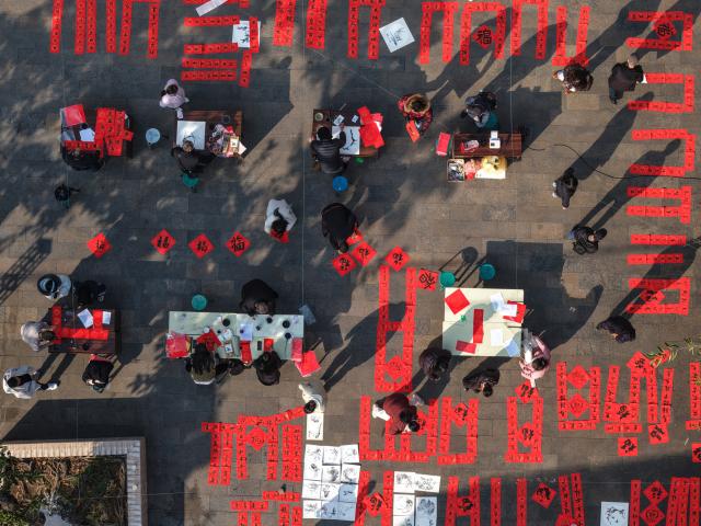 (251229) -- BEIJING, Dec. 29, 2025 (Xinhua) -- An aerial drone photo shows people writing new year couplets in Miyi County of Panzhihua City, southwest China's Sichuan Province, Dec. 29, 2025. Various activities are held across China to celebrate the upcoming new year. (Photo by Li Xiangyu/Xinhua)