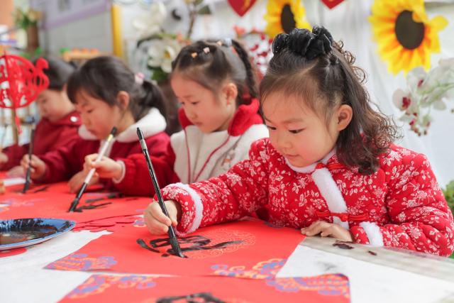 (251229) -- BEIJING, Dec. 29, 2025 (Xinhua) -- Children write the Chinese character "Fu," which means good fortune, in a kindergarten in Guiyang City, southwest China's Guizhou Province, Dec. 29, 2025. Various activities are held across China to celebrate the upcoming new year. (Photo by Yuan Fuhong/Xinhua)