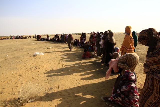 (251229) -- AL-DABBAH, Dec. 29, 2025 (Xinhua) -- Displaced people wait in a queue to get water at Al-Affad displacement camp in Al-Dabbah city, northern Sudan, Nov. 13, 2025. TO GO WITH: "Roundup: Sudan's 2025 -- a year of shifting fronts, deepening crises" (Photo by Mohamed Khidir/Xinhua)