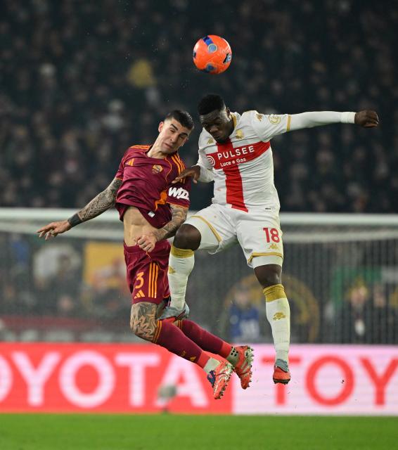 (251230) -- ROME, Dec. 30, 2025 (Xinhua) -- Roma's Gianluca Mancini (L) vies with Genoa's Caleb Ekuban during a Serie A football match between Roma and Genoa in Rome, Italy, Dec. 29, 2025. (Photo by Alberto Lingria/Xinhua)