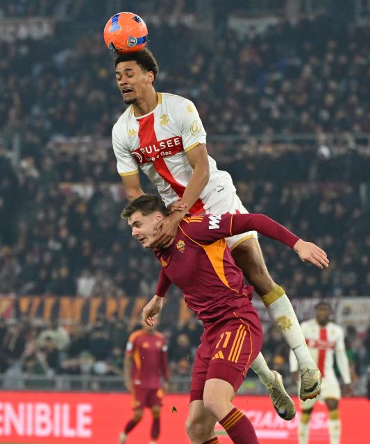 (251230) -- ROME, Dec. 30, 2025 (Xinhua) -- Roma's Evan Ferguson (bottom) vies with Genoa's Sebastian Otoa during a Serie A football match between Roma and Genoa in Rome, Italy, Dec. 29, 2025. (Photo by Alberto Lingria/Xinhua)