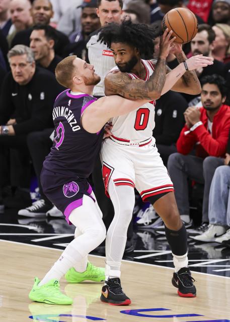 (251230) -- CHICAGO, Dec. 30, 2025 (Xinhua) -- Chicago Bulls' Coby White (R) keeps the ball from Minnesota Timberwolves' Donte DiVincenzo during the 2025-2026 NBA regular season basketball game between Minnesota Timberwolves and Chicago Bulls in Chicago, the United States, Dec. 29, 2025. (Photo by Joel Lerner/Xinhua)
