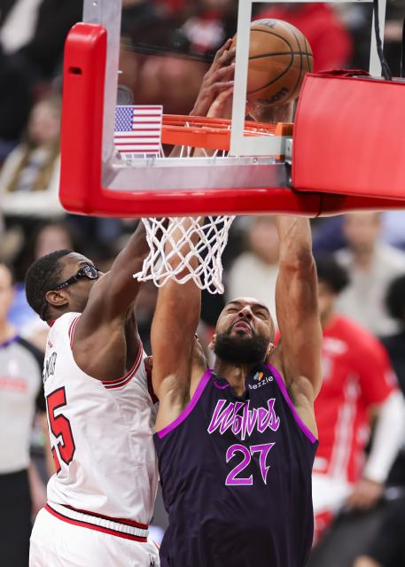 (251230) -- CHICAGO, Dec. 30, 2025 (Xinhua) -- Chicago Bulls' Jalen Smith (L) blocks the shot of Minnesota Timberwolves' Rudy Gobert during the 2025-2026 NBA regular season basketball game between Minnesota Timberwolves and Chicago Bulls in Chicago, the United States, Dec. 29, 2025. (Photo by Joel Lerner/Xinhua)